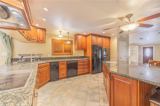 kitchen featuring black appliances, decorative light fixtures, sink, and dark stone counters