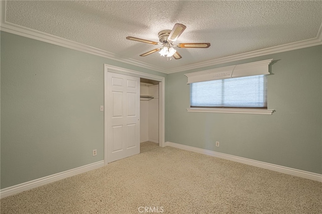 unfurnished bedroom with ceiling fan, crown molding, a textured ceiling, and a closet