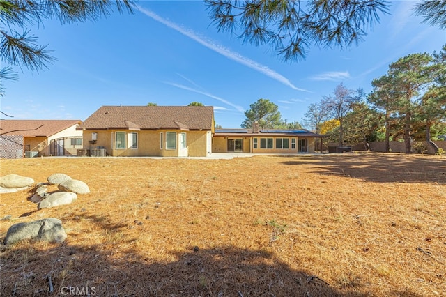 rear view of property with a yard