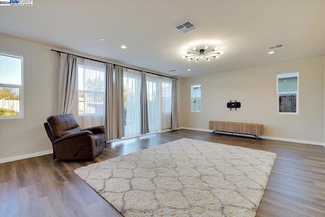 sitting room with radiator and dark wood-type flooring