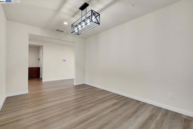 unfurnished room with light hardwood / wood-style flooring