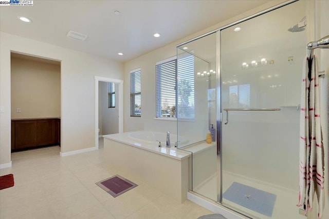 bathroom featuring tile patterned floors and independent shower and bath