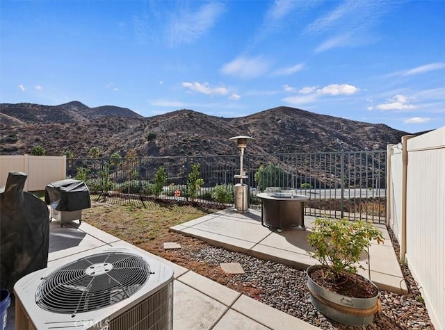 view of patio featuring a mountain view and central AC