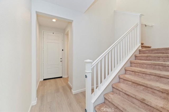 stairway featuring wood-type flooring