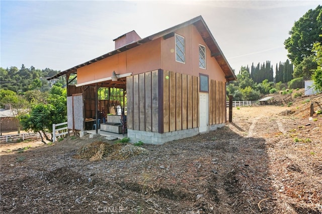 view of home's exterior with an outbuilding