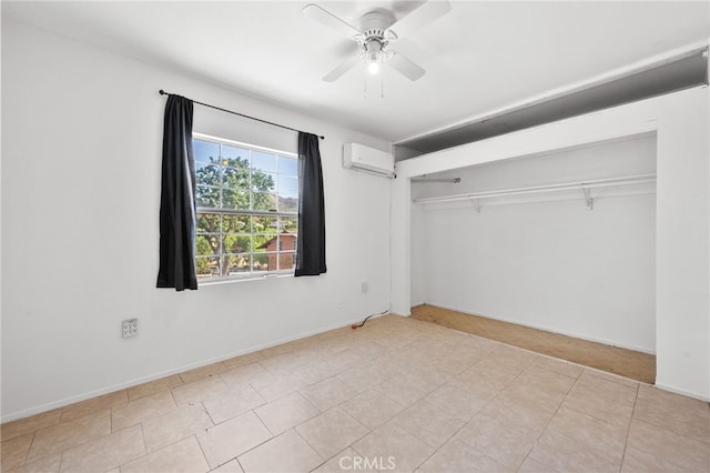 unfurnished bedroom with ceiling fan, an AC wall unit, and a closet