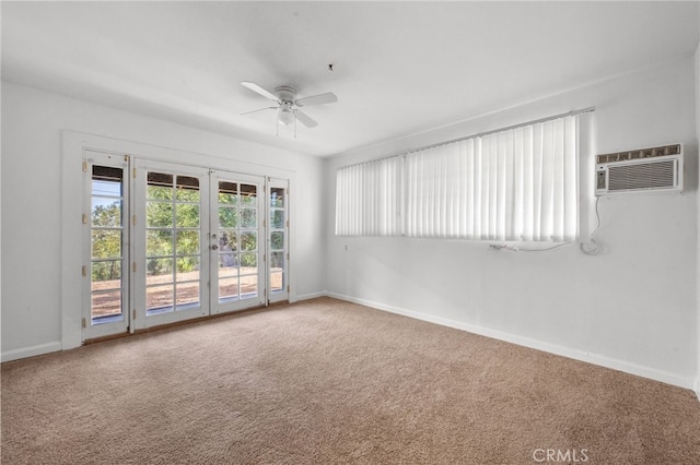 carpeted empty room with a wall mounted air conditioner, ceiling fan, and french doors