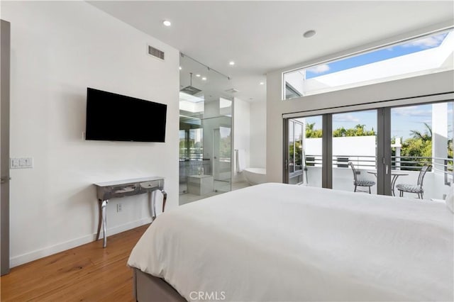 bedroom with french doors, access to outside, and wood-type flooring