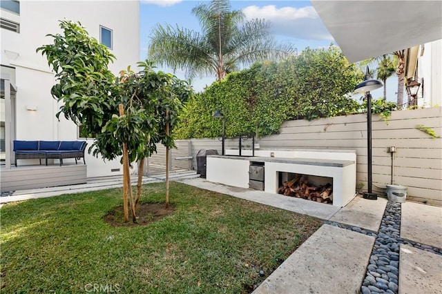 view of community featuring a lawn and a patio area