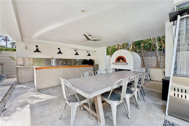 view of patio with ceiling fan and exterior fireplace