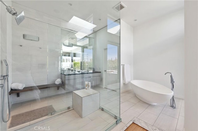 bathroom with tile patterned floors, separate shower and tub, and vanity