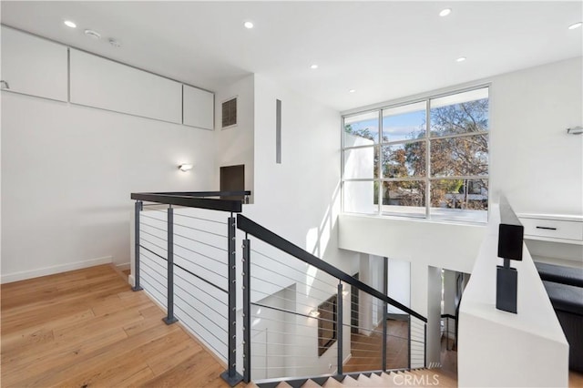 staircase with wood-type flooring