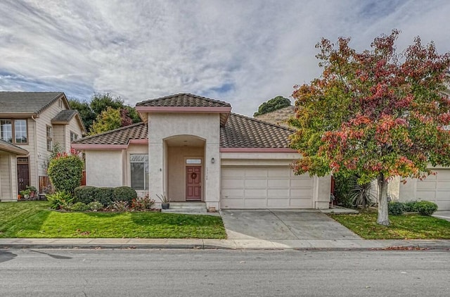 view of front of home with a garage and a front lawn