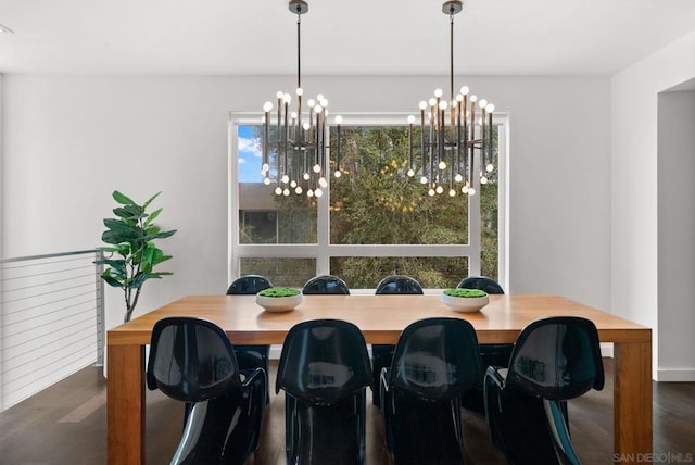 dining area featuring a wealth of natural light, dark hardwood / wood-style floors, and a notable chandelier