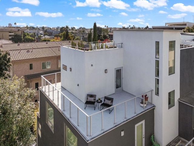 rear view of property featuring a balcony