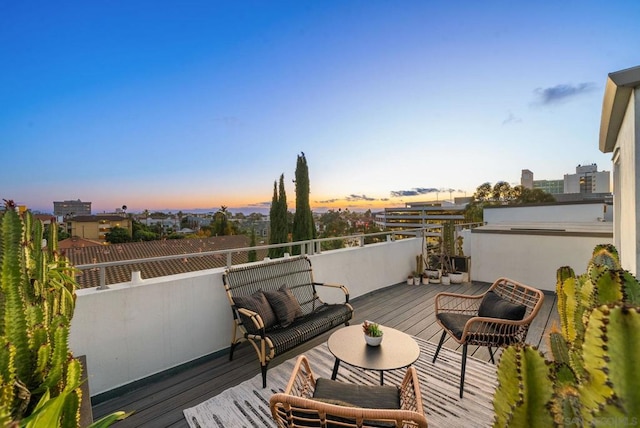 deck at dusk with outdoor lounge area