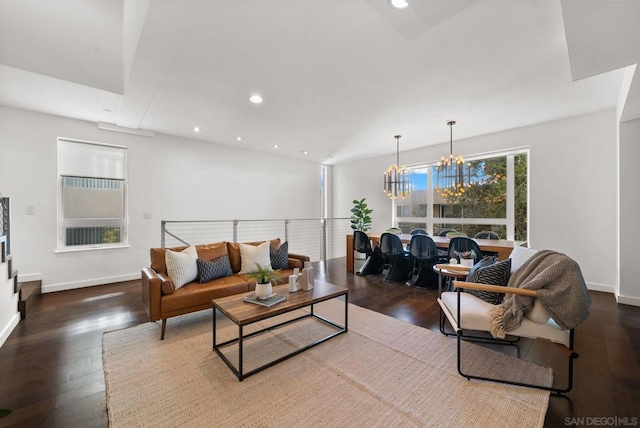 living room featuring a chandelier and dark wood-type flooring