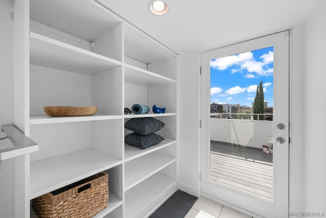 walk in closet with light tile patterned flooring