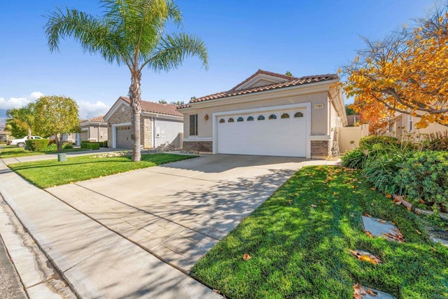 mediterranean / spanish-style house featuring a garage and a front lawn