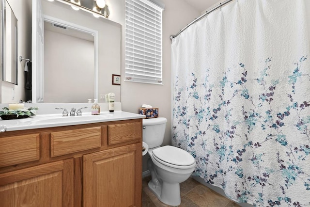 bathroom featuring tile patterned floors, curtained shower, vanity, and toilet