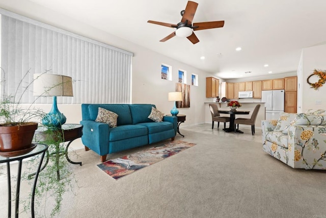 carpeted living room featuring ceiling fan