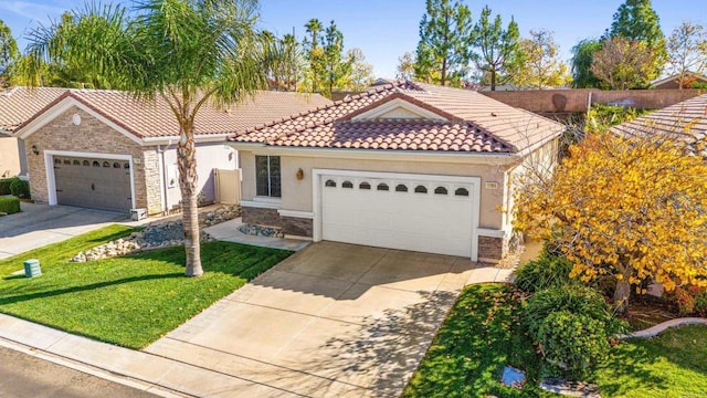 view of front of property featuring a front yard and a garage