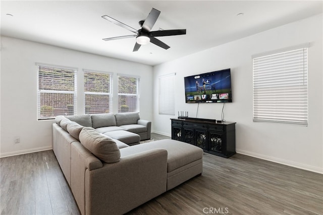 living room featuring ceiling fan and dark wood-type flooring