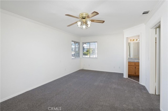 unfurnished bedroom with connected bathroom, dark carpet, ceiling fan, and crown molding