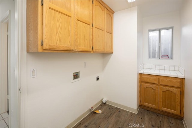 laundry area featuring cabinets, washer hookup, hookup for an electric dryer, hookup for a gas dryer, and dark hardwood / wood-style floors