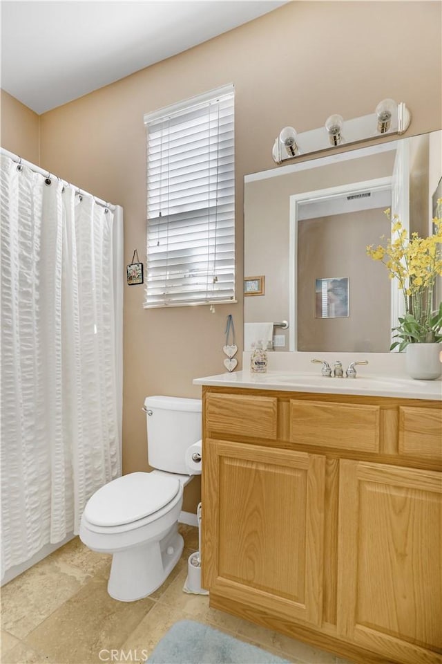 bathroom with tile patterned flooring, vanity, and toilet