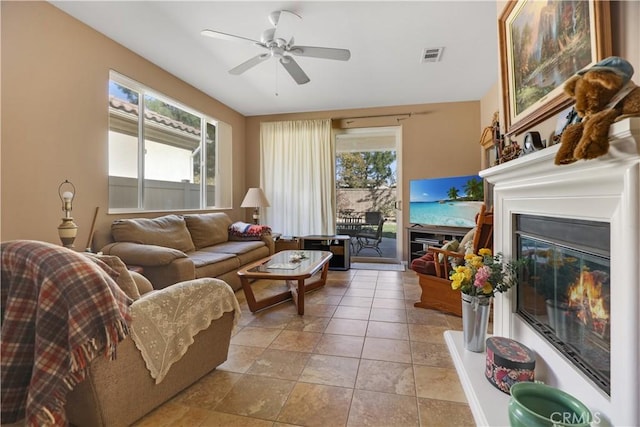 living room featuring a wealth of natural light and ceiling fan