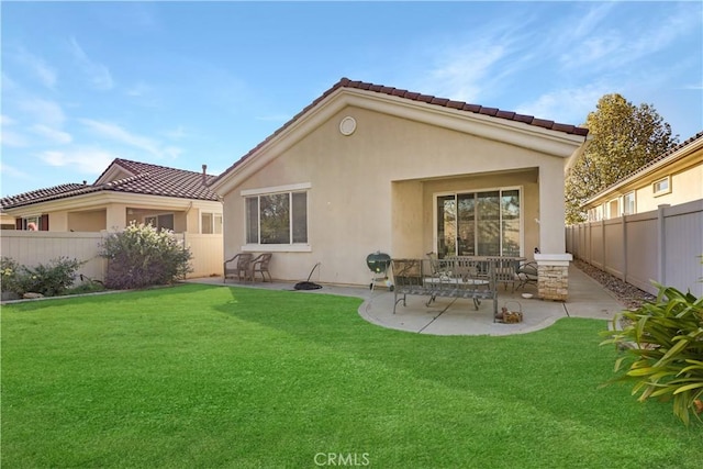 back of house featuring a yard and a patio area