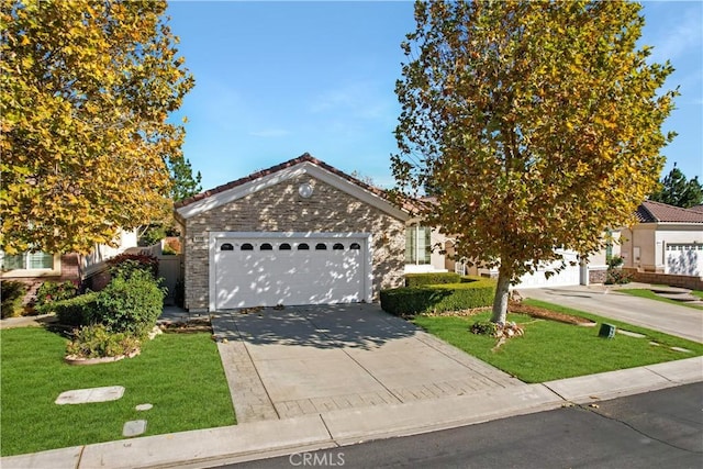 view of front of home with a front yard and a garage