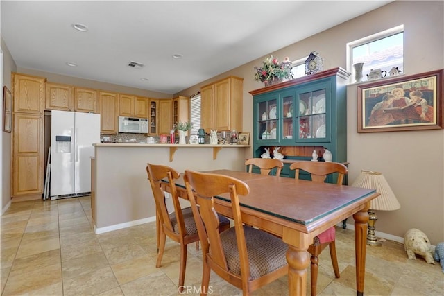 dining area featuring light tile patterned flooring