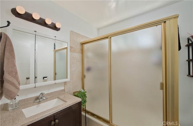 bathroom with combined bath / shower with glass door and vanity