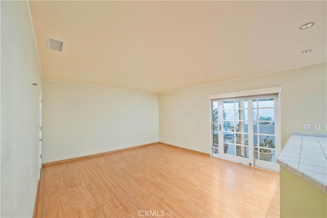 spare room featuring light hardwood / wood-style floors