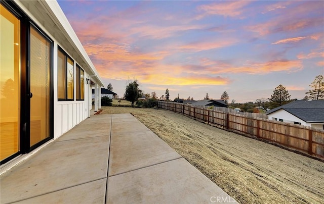 yard at dusk with a patio area