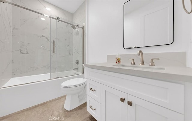 full bathroom with enclosed tub / shower combo, vanity, and toilet