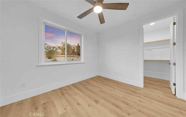 unfurnished room with ceiling fan and light wood-type flooring