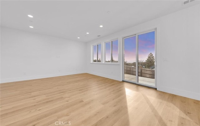 spare room with light hardwood / wood-style flooring