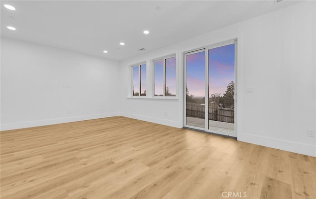 spare room with light hardwood / wood-style flooring