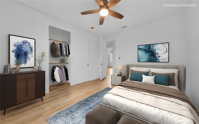 bedroom featuring light wood-type flooring, ceiling fan, and a closet