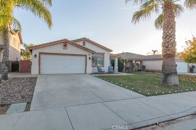 ranch-style home featuring a front lawn and a garage