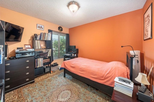 bedroom with carpet and a textured ceiling