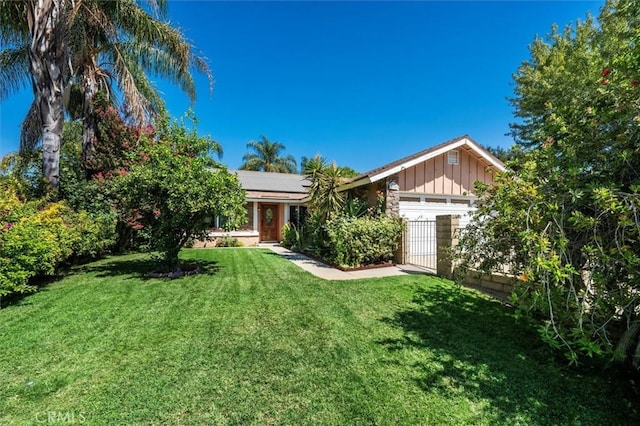 ranch-style house featuring solar panels, a garage, and a front yard