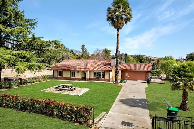 view of front of property with a garage and a front lawn