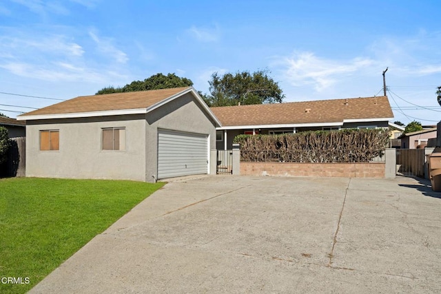 view of front of property with a front yard and a garage