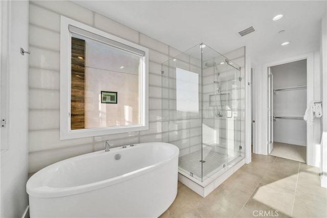 bathroom featuring shower with separate bathtub and tile patterned floors