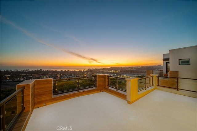 patio terrace at dusk with a balcony