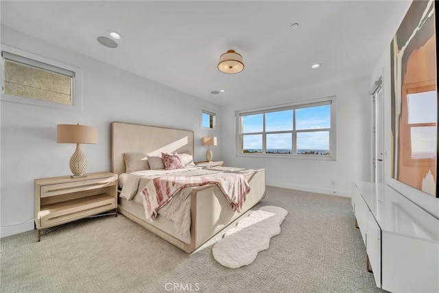 carpeted bedroom with multiple windows